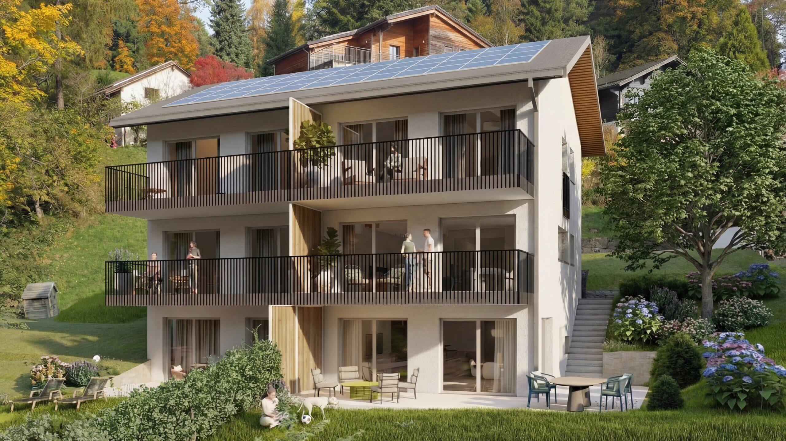 Neues dreigeschossiges Wohngebäude mit hellen Fassaden, Holzdetails, grossen Balkonen, Fensterfronten, Solarpanels auf dem Dach und einem abfallenden, baumbestandenen Garten.